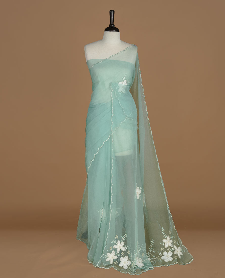Aqua colour crush organza saree featuring white floral work with beats & sequins, highlighting scalp with beats worked border, paired with matching blouse piece.