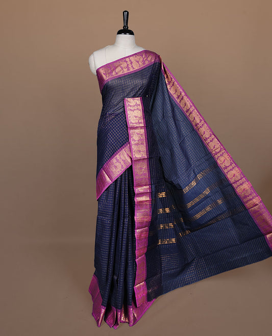 Navy blue colour sungudi cotton saree featuring gold zari check pattern across body, contrast Magenta colour with gold zari peacock and floral pattern on border, without blouse piece.