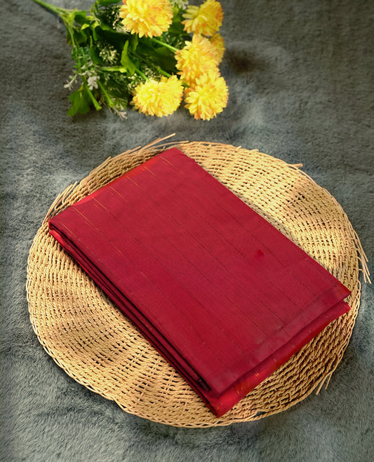 Maroon colour silk cotton saree featuring with delicate vertical copper zari lines on the body, Crafted without a border for a classy touch, Comes with a matching blouse for a perfectly coordinated look.