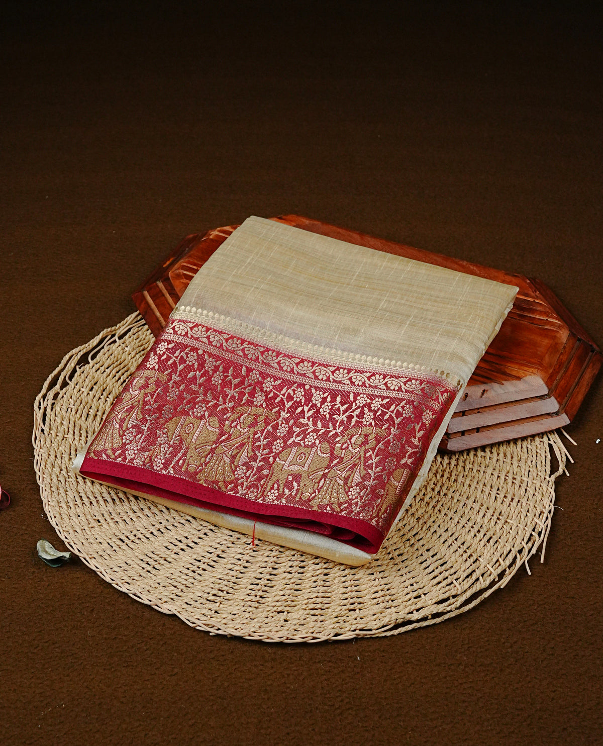 Light gold tussar saree featuring Elegant plain body, complemented by contrast Maroon colour with Gold zari Floral kodi with Women & Cow Pattern border, comes with matching blouse piece.