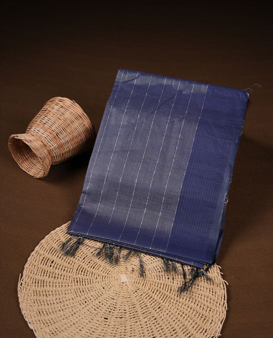 Dark blue colour semi jute saree highlighting gold zari striped body, without border and paired with matching blouse.