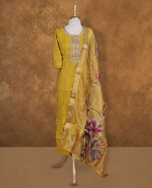 Olive yellow colour churidar set featuring elegant white thread embroidery on the neckline, sleeves, and scattered motifs across the body, Paired with a matching floral printed pattern dupatta