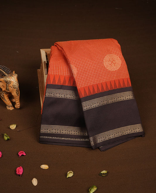 Dark Rust orange colour semi silk saree featuring gold zari checks with floral motifs on body highlighting contrast dark chocolate gold zari small mango border , paired with matching blouse