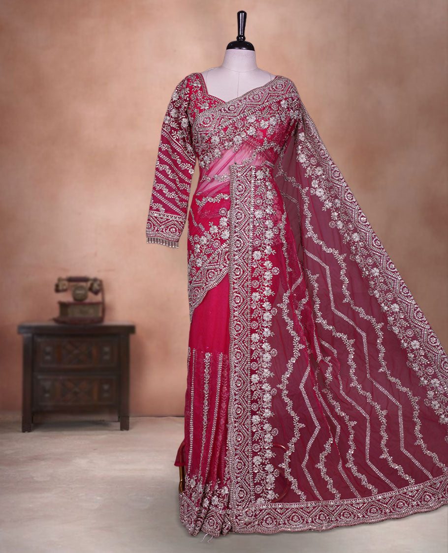 Rani Pink Colour net designer Wedding saree featuring all over floral embroidery with sequin detailing and an ornate scalloped border, finished with a matching embellished blouse.