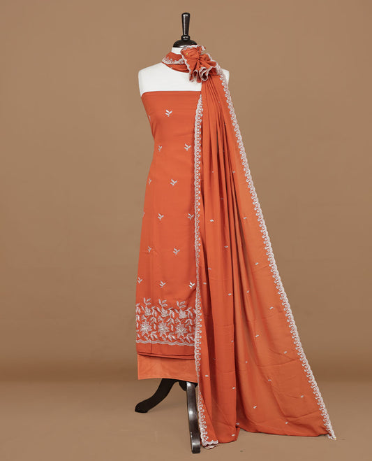 Orange colour churidhar material featuring gold thread floral pattern on body, paired with matching bottom & dupatta.