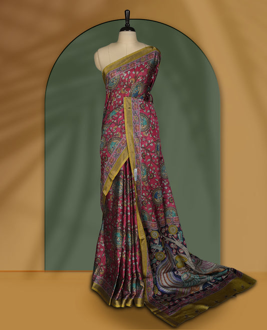 Reddish maroon colour saree adorned with intricate floral and paisley motifs, featuring a vibrant Madhubani style pallu and olive gold border & Paired with a matching blouse.