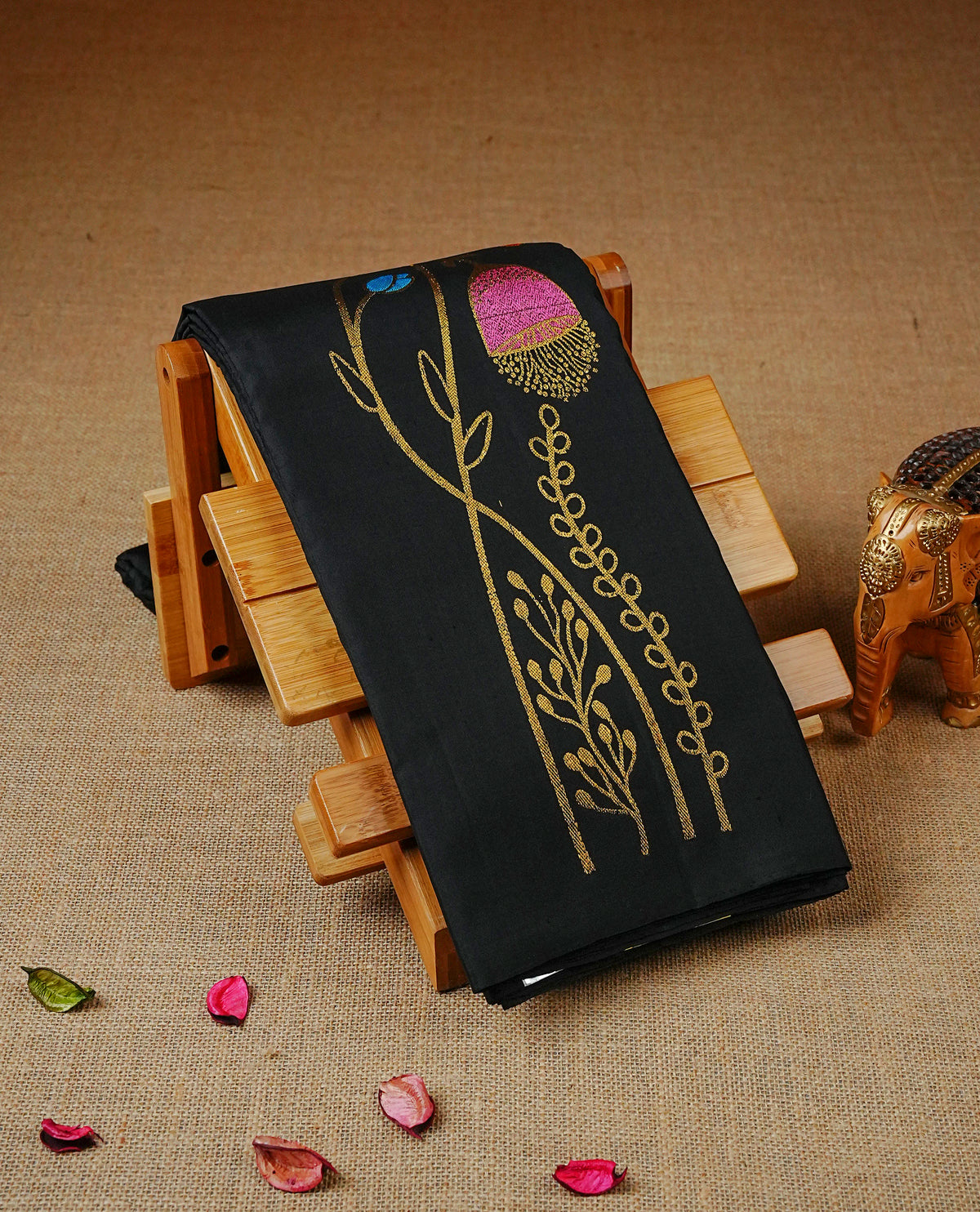 Black Colour Traditional Kancheepuram Saree featuring elegant multicolour floral vine embroidery on the body, complemented by a rich gold zari woven pallu with Peacock and geometric motifs, paired with a matching blouse piece.