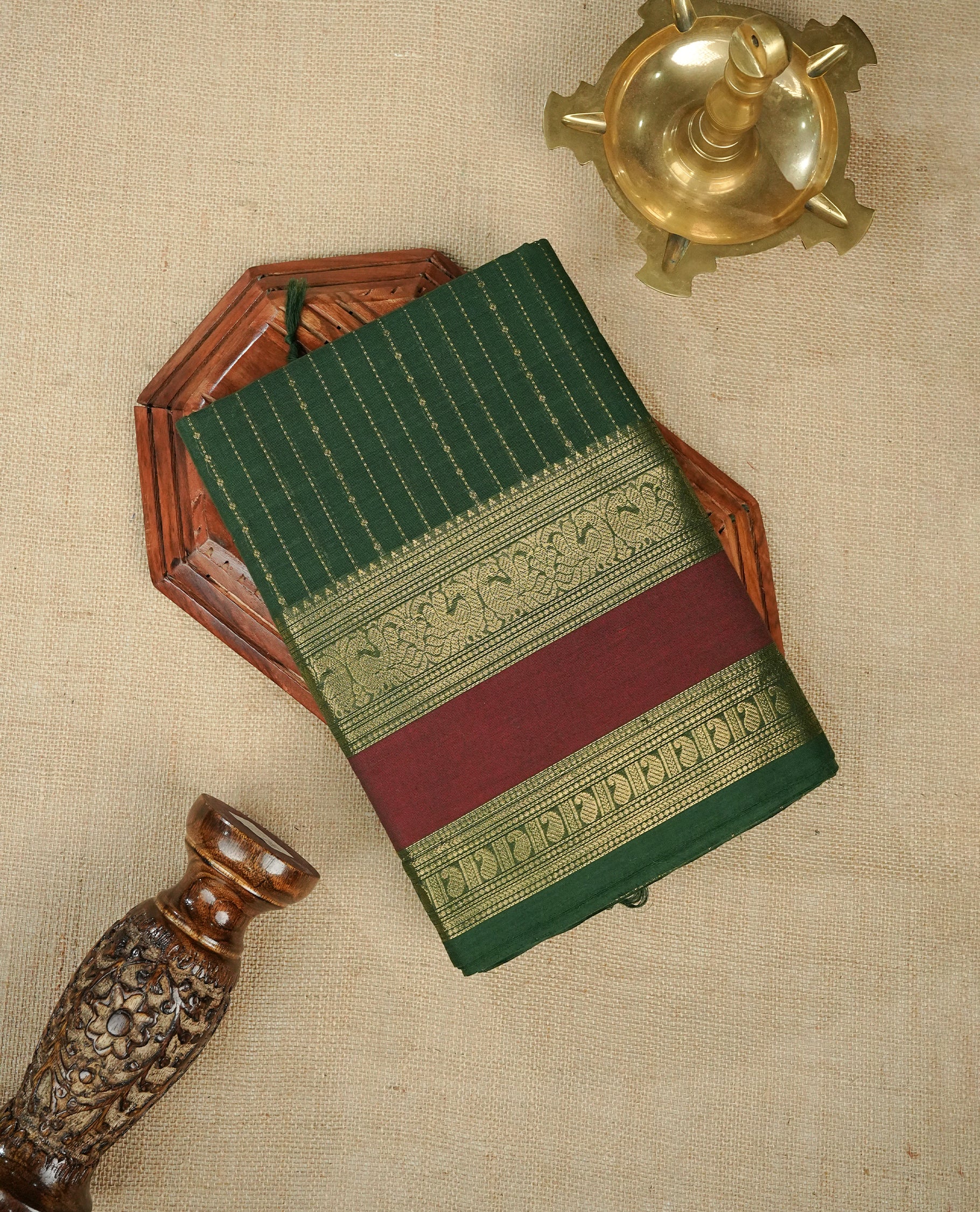 Green colour chettinad cotton saree Featuring Gold zari Strips on body, complemented by contrast Maroon colour with zari border, comes with matching blouse piece.