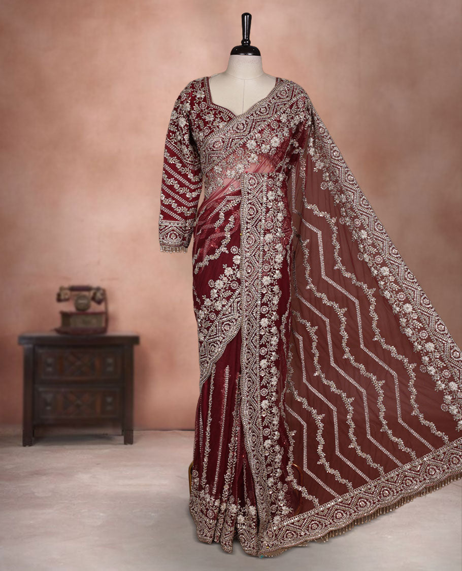 Maroon Colour net designer Wedding saree featuring all over floral embroidery with sequin detailing and an ornate scalloped border, finished with a matching embellished blouse.
