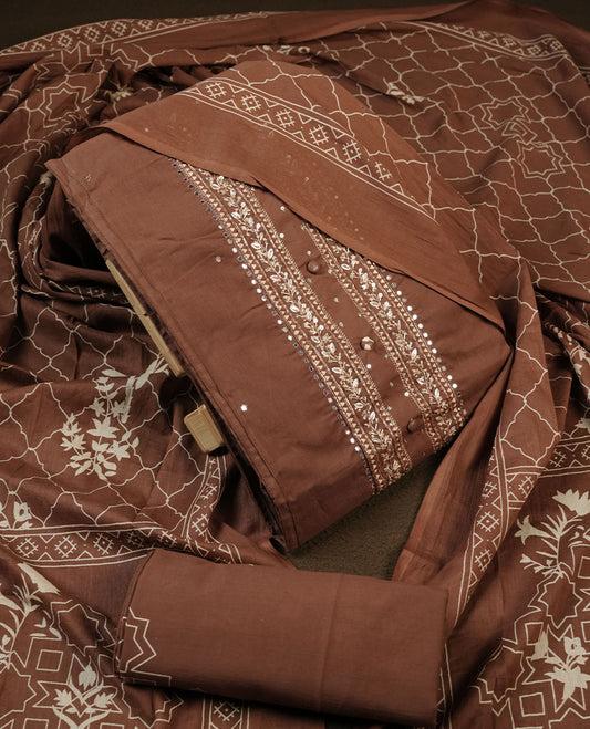 Chocolate brown colour churidar material featuring delicate thread embroidery with subtle mirror accents on the front panel, paired with a printed dupatta and matching bottom.