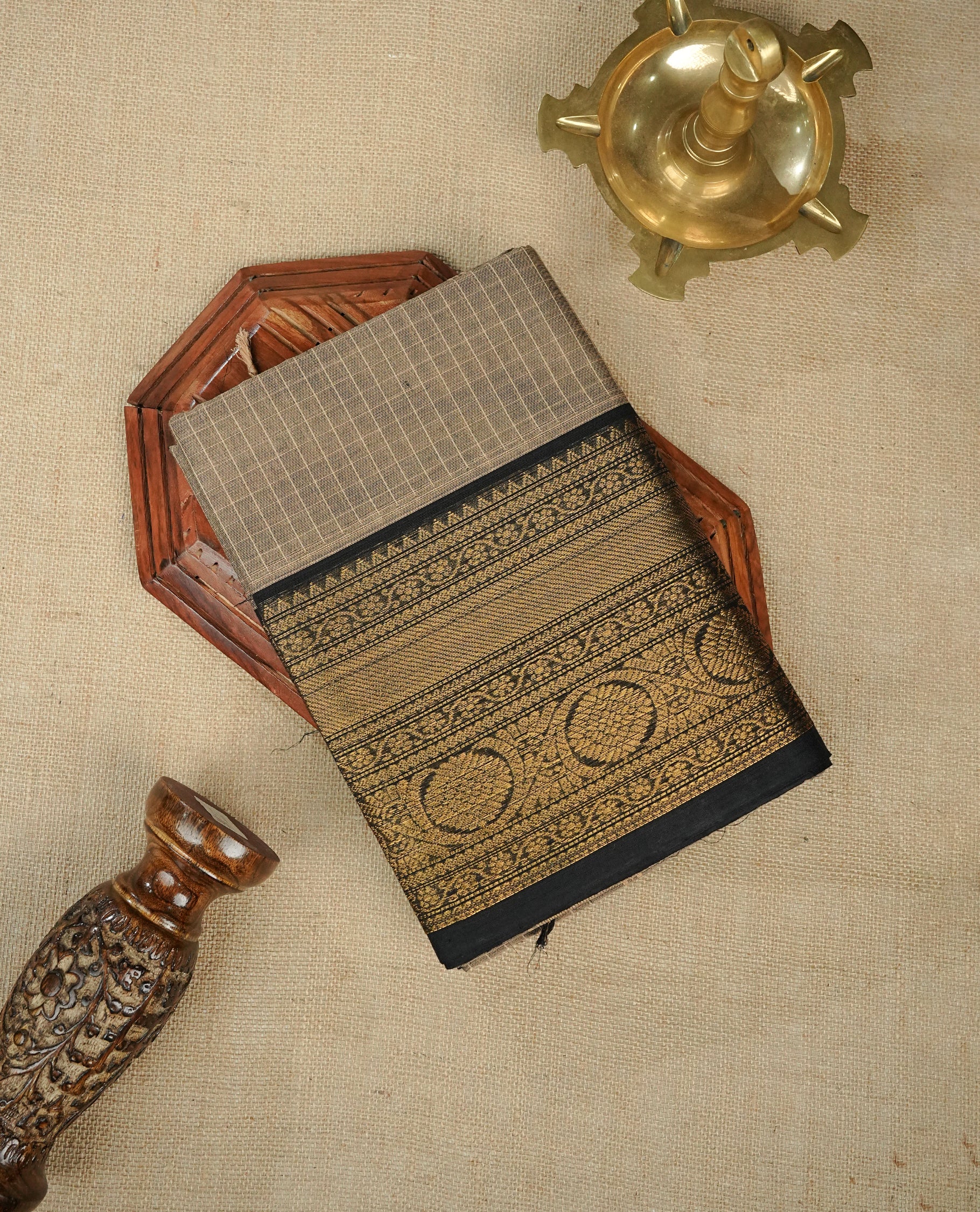 Beige colour chettinad cotton saree featuring Strip pattern on body, gold zari on Contrast Black colour border, comes with matching blouse piece.