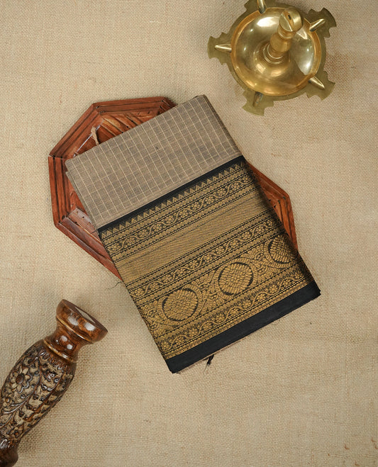 Beige colour chettinad cotton saree featuring Strip pattern on body, gold zari on Contrast Black colour border, comes with matching blouse piece.
