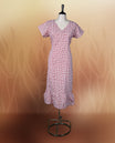 Off white colour kurthi with red and peach colour block style prints, V neckline, and short sleeves, Designed with a flattering silhouette and ruffled hem, perfect for everyday comfort and stylish casual wear.