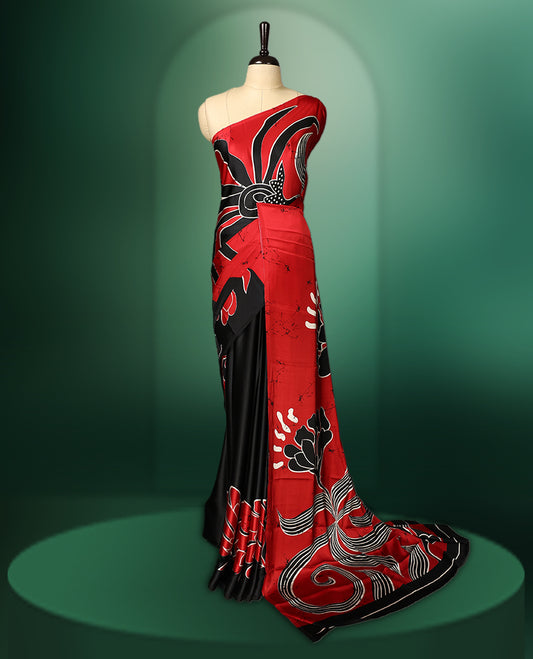 Red and black colour semi modal saree featuring bold abstract floral and swirl patterns, highlighted with contemporary design elements, and paired with a coordinated blouse