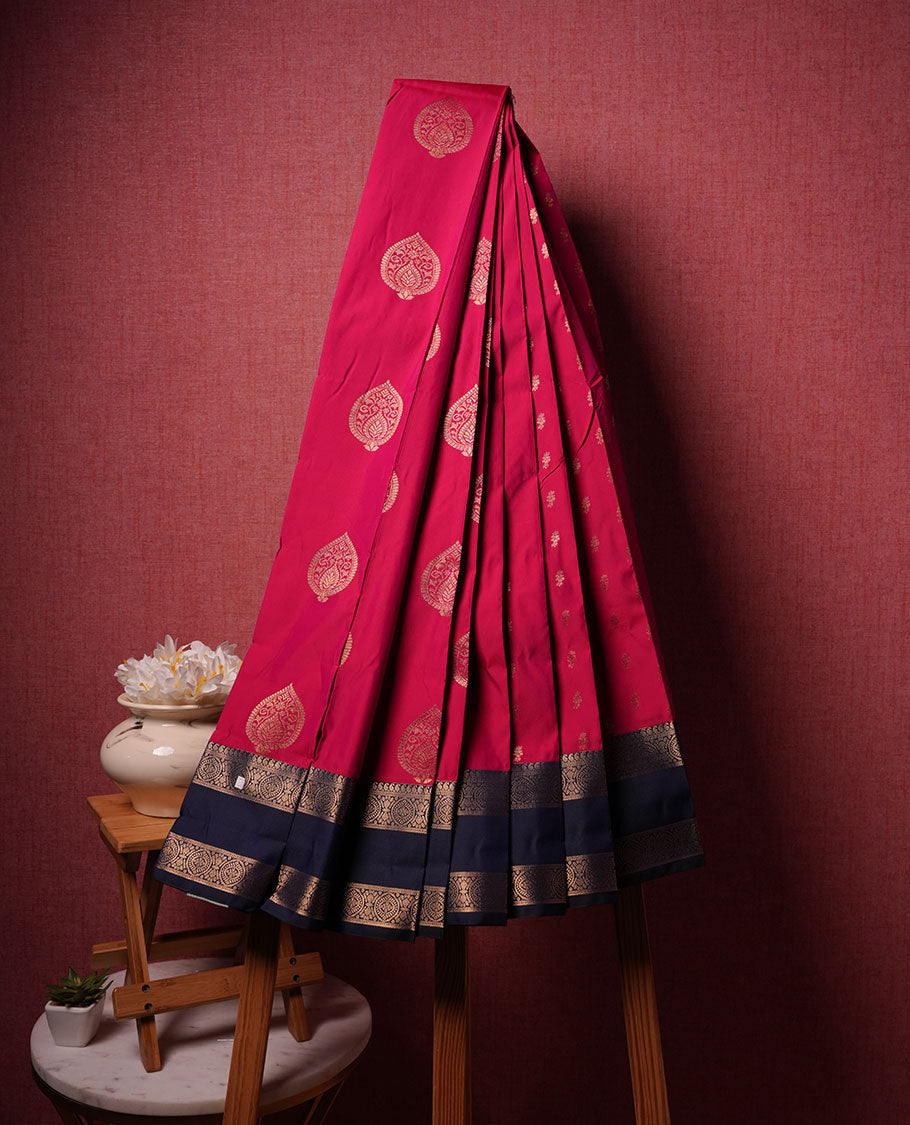 Rani pink colour semi silk saree highlighting gold zari motifs across body, featuring contrast blue colour border with gold zari pattern, comes with matching blouse .