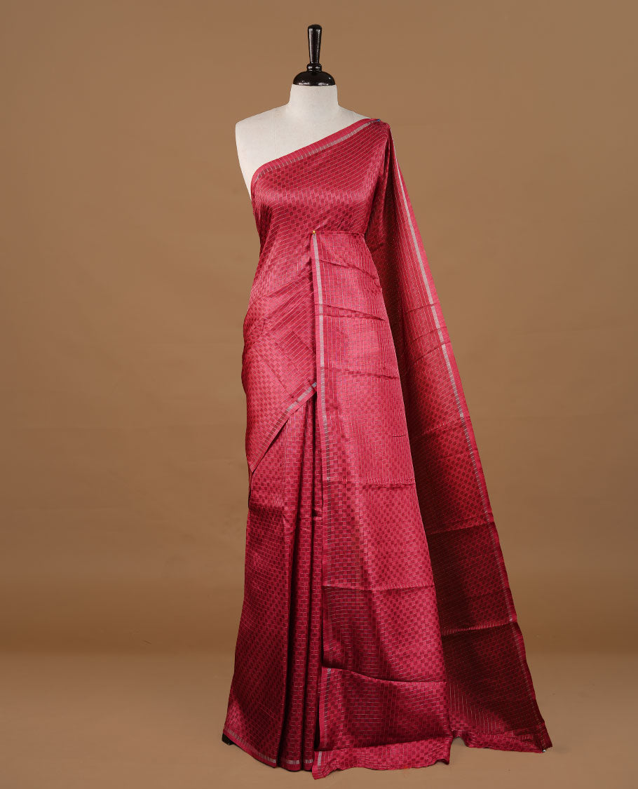 Rose Red colour Semi Tussar saree featuring an elegant zari fancy check pattern on the body, highlighted with a small border for a refined look. Comes without a blouse piece.