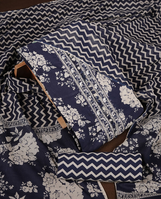 Blue colour churidar set with cream floral print, stone and thread embroidery and detailing, paired with matching pant and dupatta.