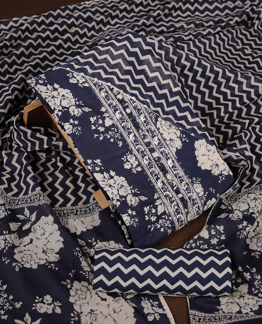 Blue colour churidar set with cream floral print, stone and thread embroidery and detailing, paired with matching pant and dupatta.