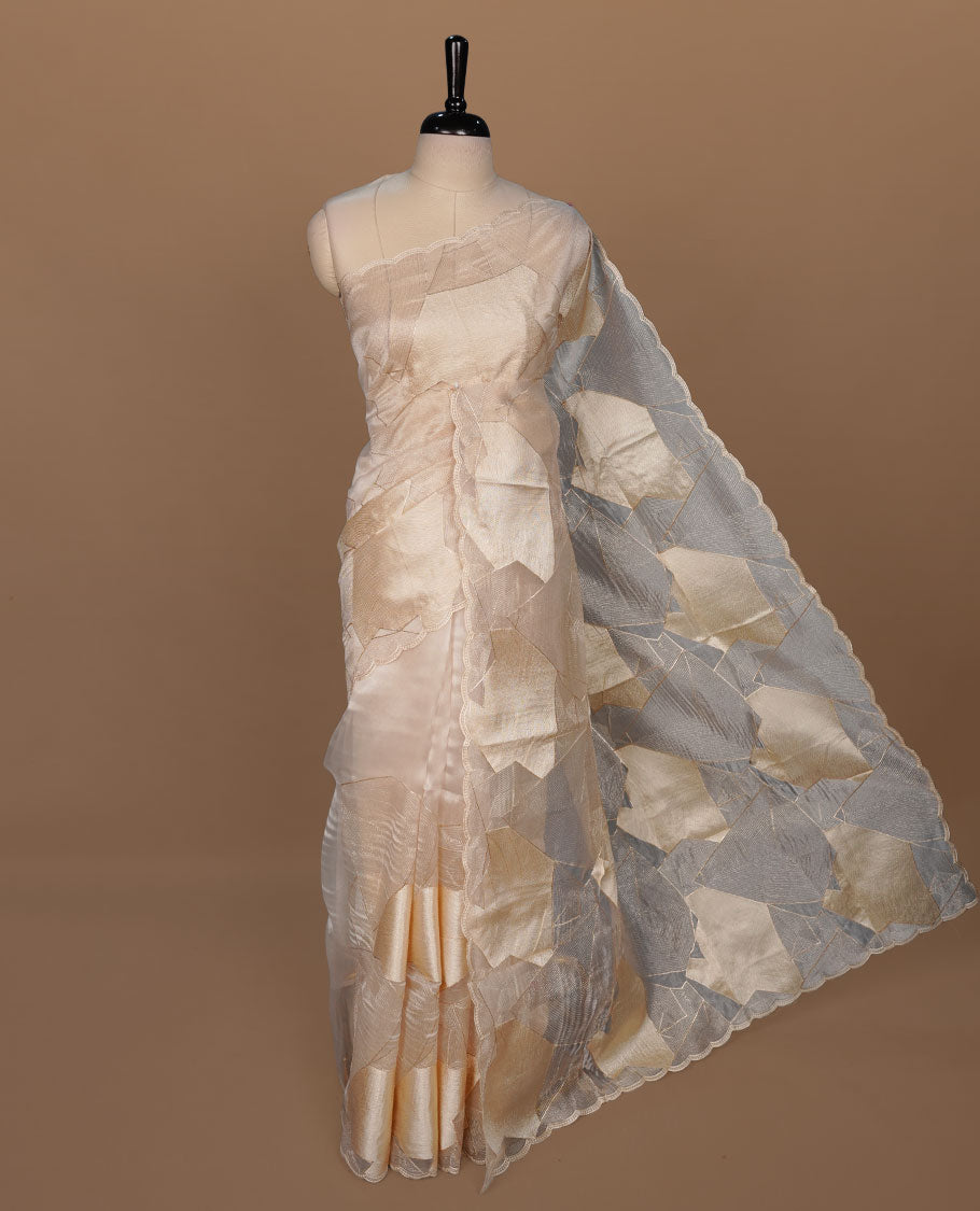 Beige colour Organza designer saree featuring a thread geometric pattern across the body, enhanced with a piping border and cut beats work on matching blouse piece.