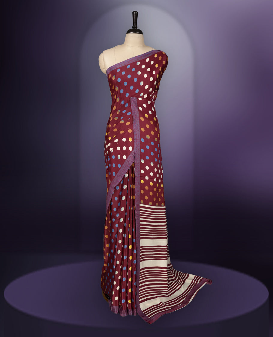 Maroon colour saree with with large big polka dots on the body, self stripped pallu & Comes with a stylish matching blouse.