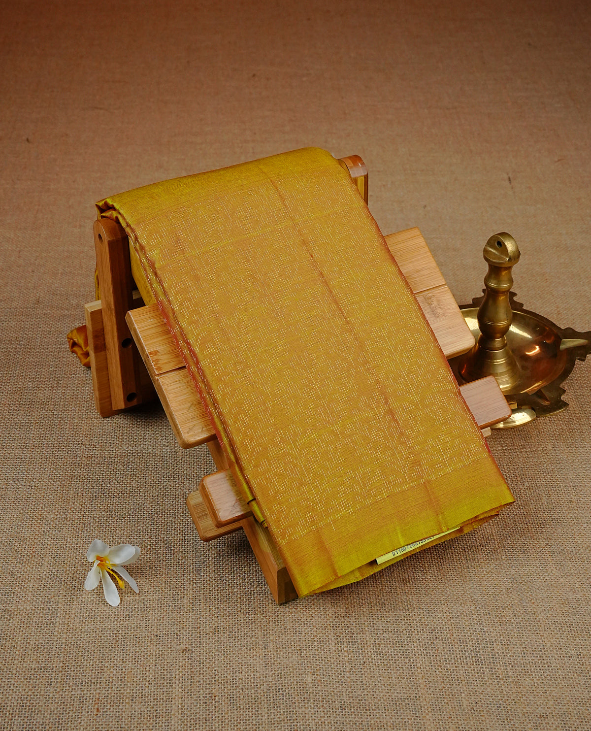 Mustard Colour soft silk saree featuring elegant self woven leaf motifs across the body, complemented by a richly woven self design pallu, paired with a matching plain blouse piece.