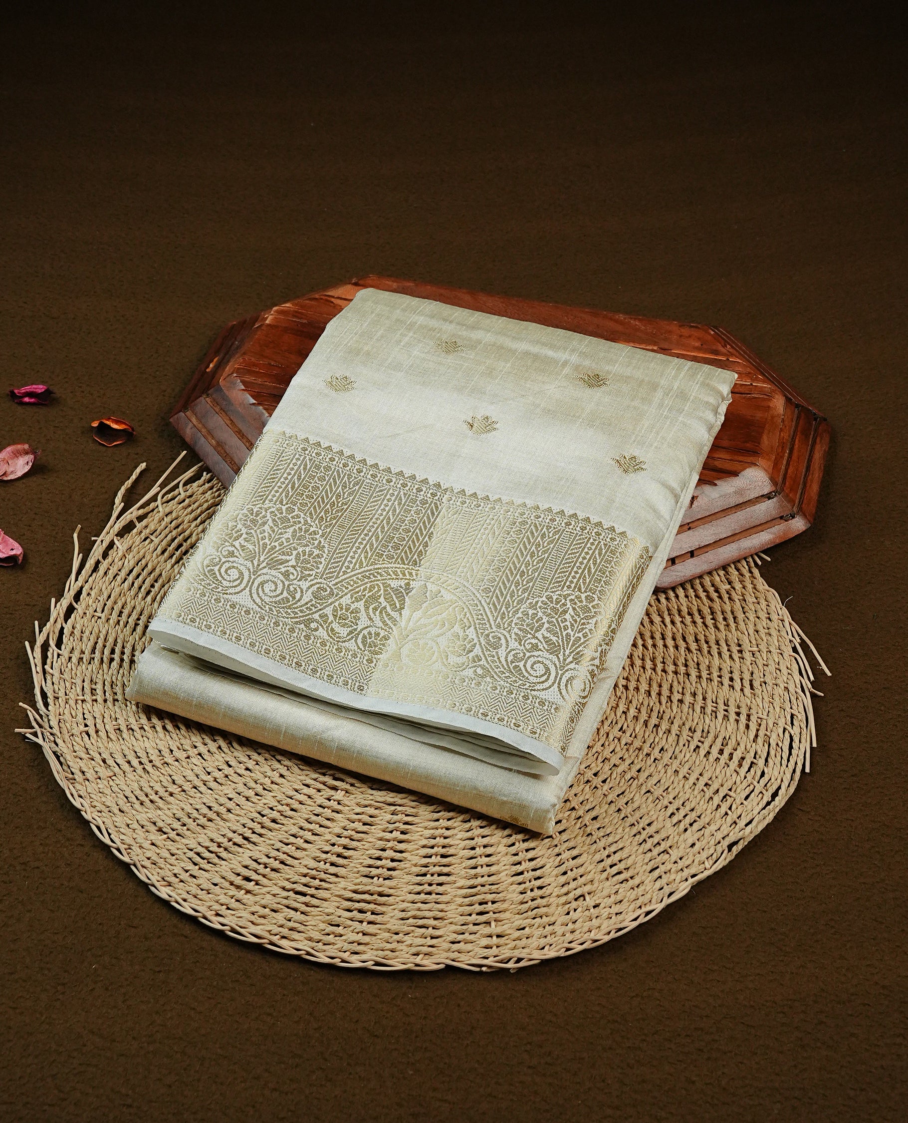 Off white gold Tussar saree featuring Gold zari buttas on body, complemented by self colour with traditional border, comes with matching blouse piece.