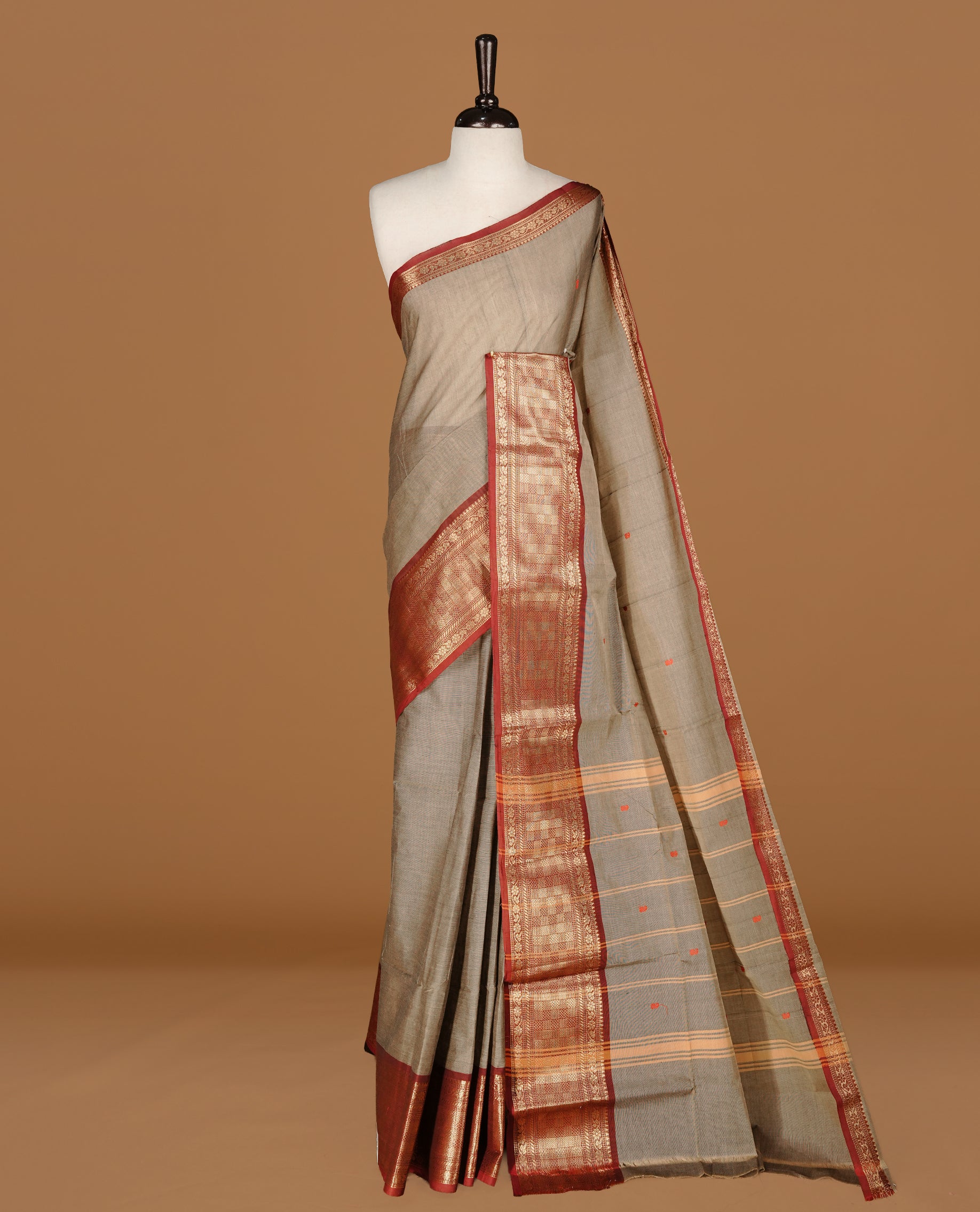 Grey colour Chettinad cotton saree featuring motifs on body , complemented by contrast Maroon colour with zari border, comes with matching blouse piece.