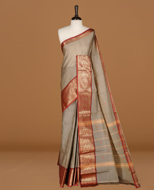 Grey colour Chettinad cotton saree featuring motifs on body , complemented by contrast Maroon colour with zari border, comes with matching blouse piece.