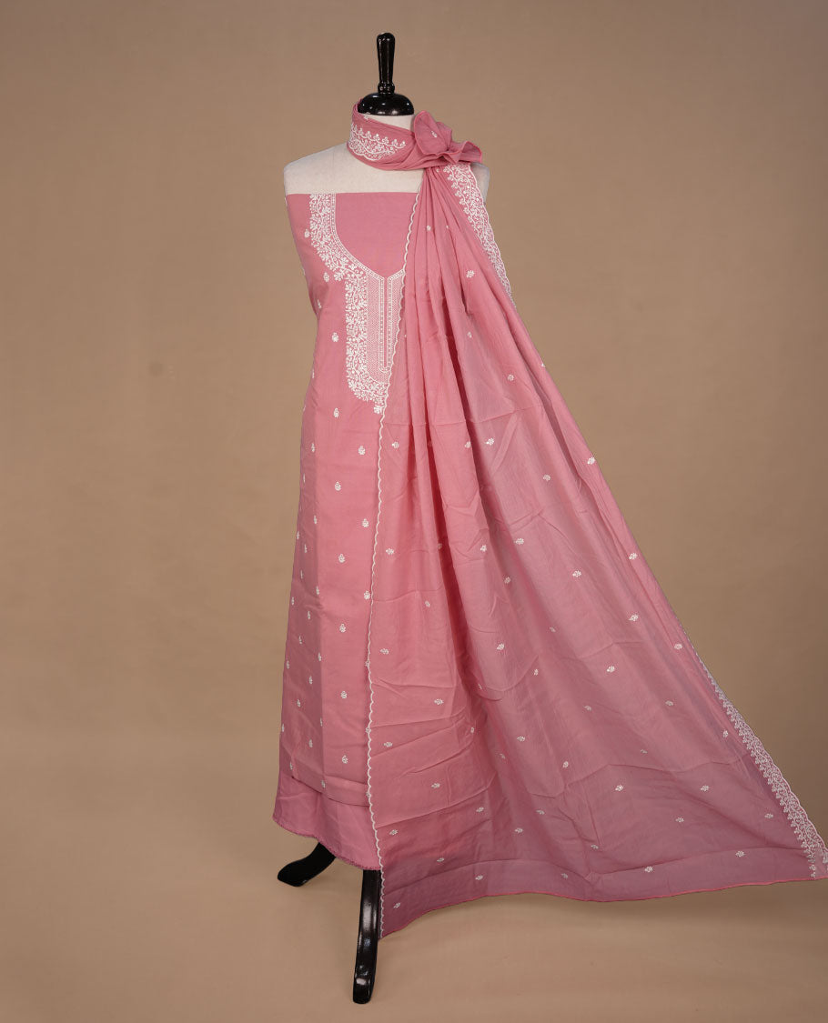 Pastel Peach colour churidar material feating white thread motifs on body and floral kodi pattern neckline, paired with matching bottom and dupatta