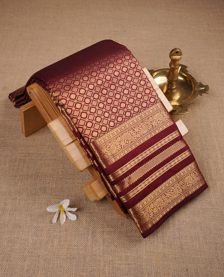 Wine maroon colour kancheepuram silk saree featuring Diamond pattern zari jacquard on body with traditional line border , paired with matching blouse piece.