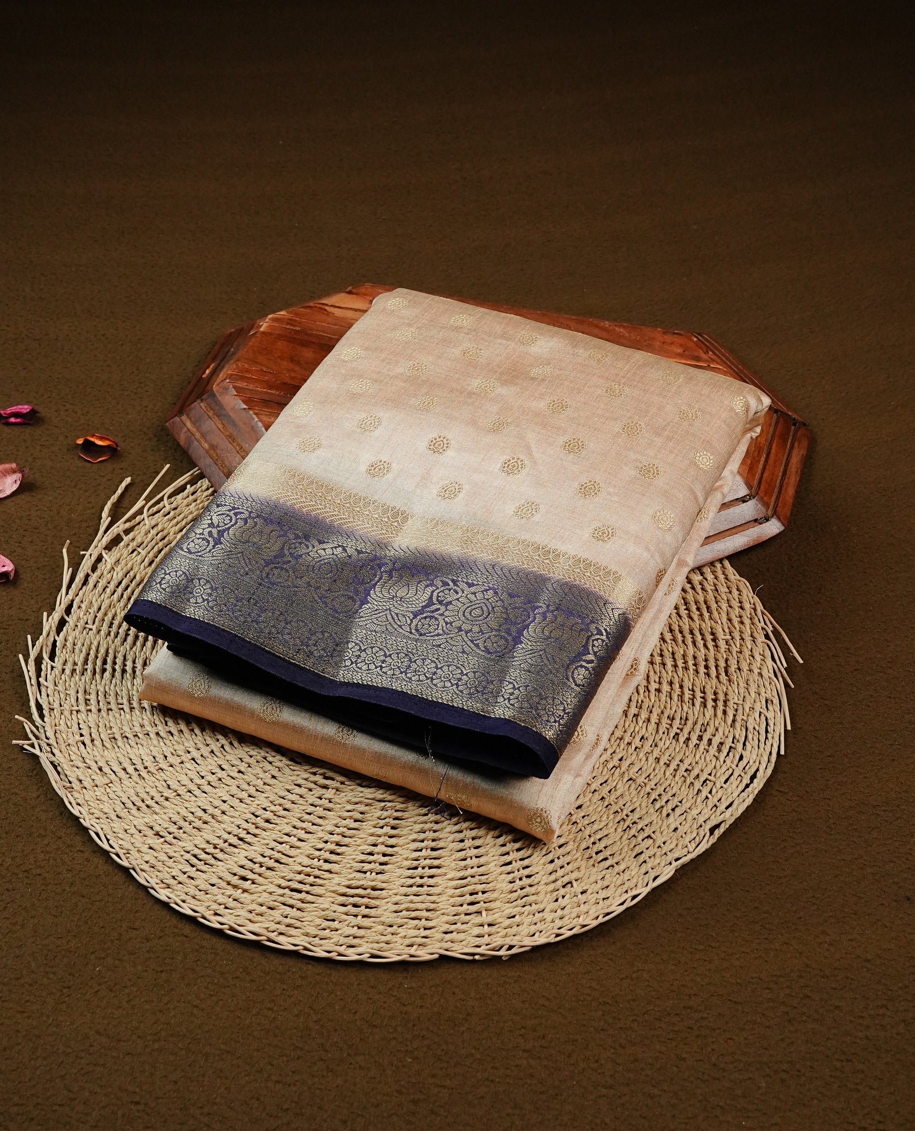 Light Gold Tussar saree featuring Gold zari buttas on body, complemented by contrast Navy Blue Colour with Gold zari border, comes with matching blouse piece.