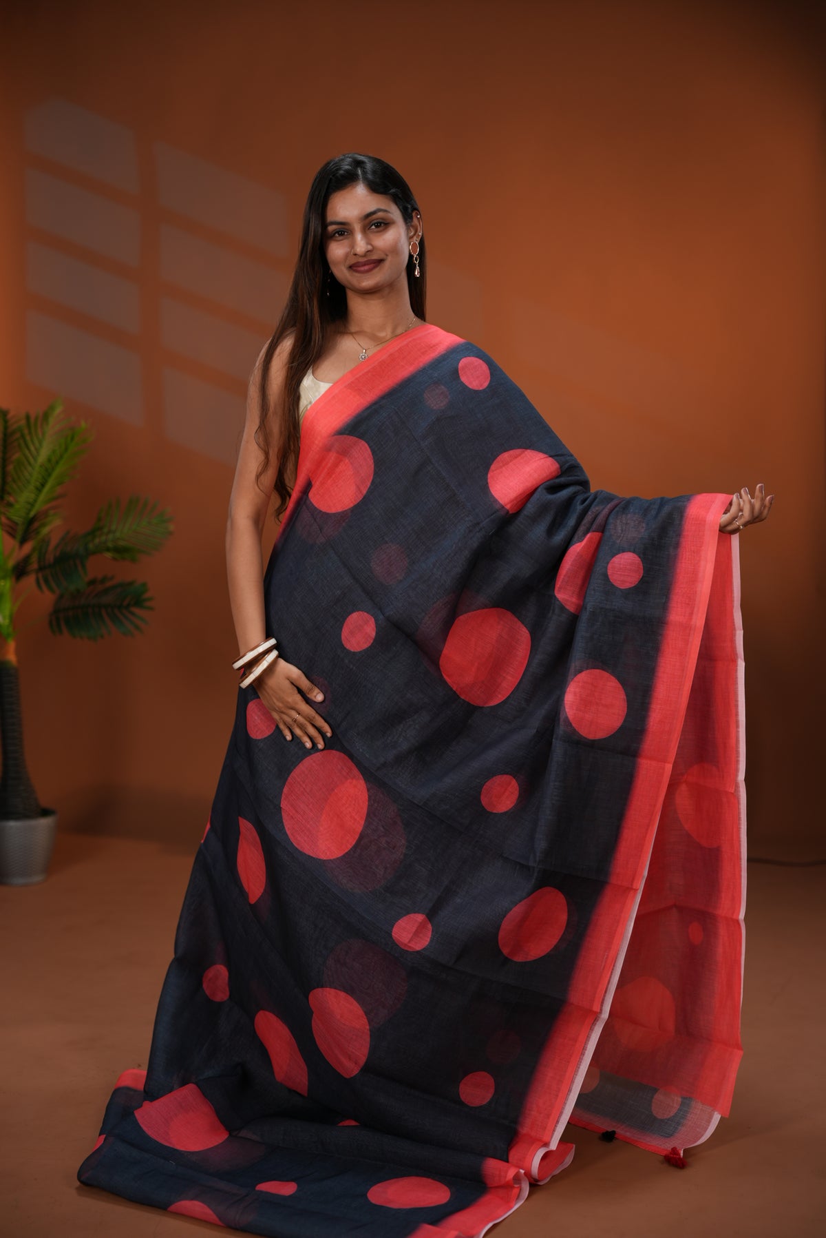 Black colour Linen saree featuring Red Polka dot on body, Contrast Border and Blouse.
