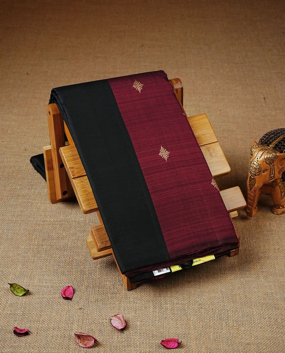 Black & Maroon Dual Colour Traditional Kancheepuram Saree featuring Gold zari motifs across the body, complemented by a matching maroon pallu with subtle gold zari motifs, paired with a matching maroon blouse piece.