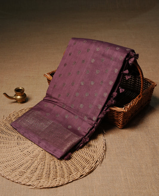 Dusted purple colour semi tussar silk saree featuring elegant Antique zari motifs across the body, designed with a subtle borderless zari finish for a sophisticated traditional look. Paired with a matching blouse piece.
