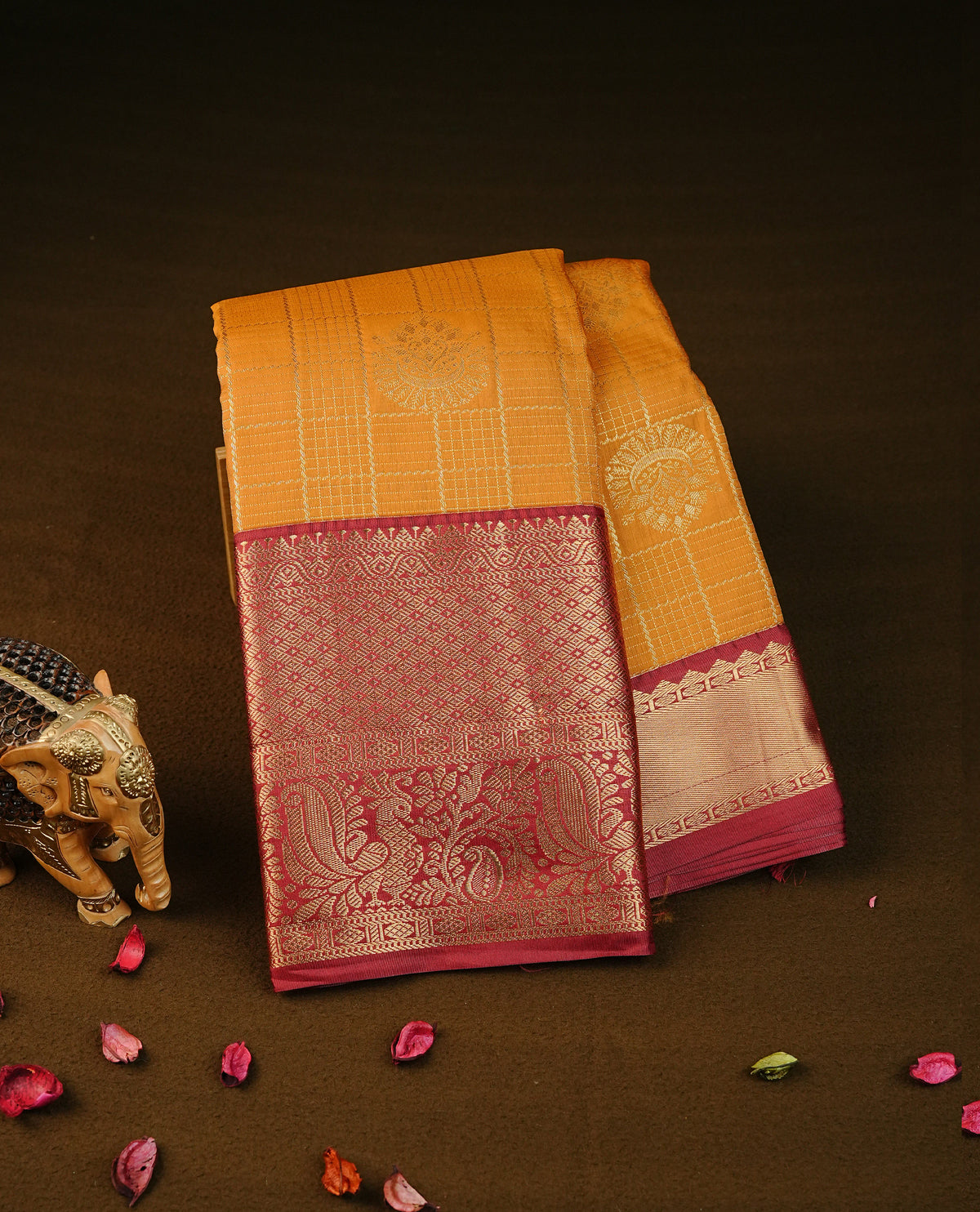 Mustard yellow colour semi wedding silk saree featuring gold zari checks with motifs on body, contrast maroon colour with peacock  traditional border on body, rich pallu comes with matching blouse piece