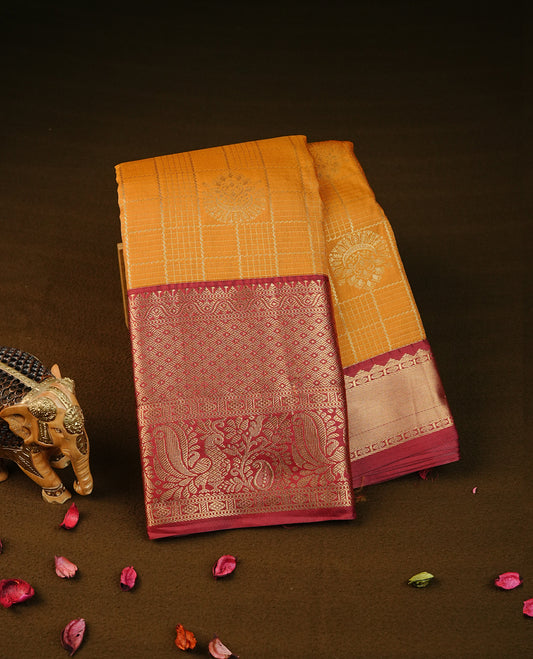 Mustard yellow colour semi wedding silk saree featuring gold zari checks with motifs on body, contrast maroon colour with peacock  traditional border on body, rich pallu comes with matching blouse piece