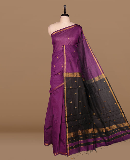 Purple colour Maheshwari cotton saree features elegant gold zari motifs across the body, a classic gold zari border, a striking contrast pallu, and a matching blouse piece.