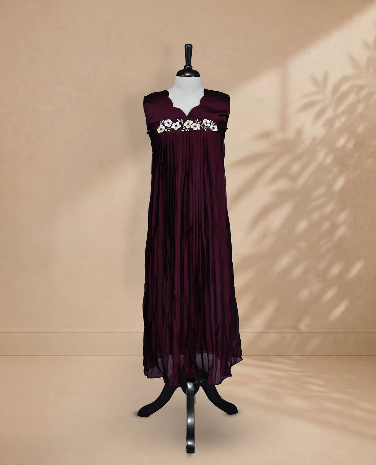 Dark Wine Coloured Sleeveless Kurti Featuring a Designed Neckline, Floral Embroidery on the Body