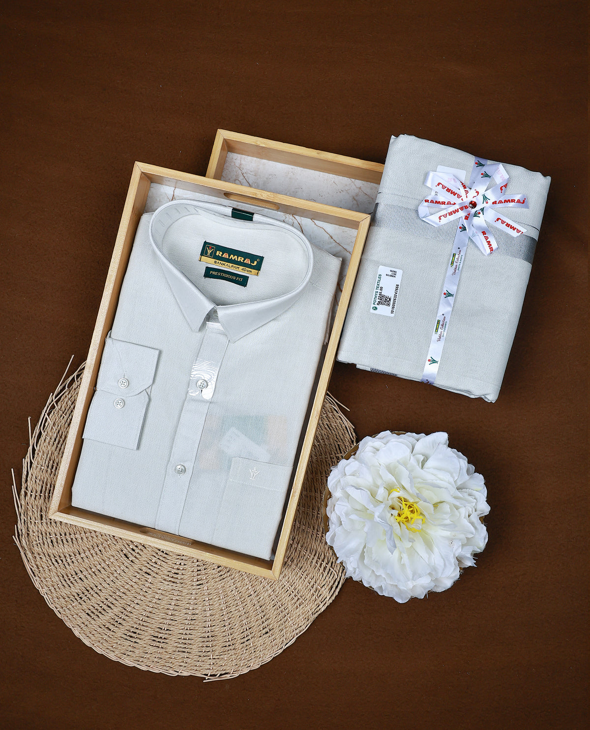 Silver colour RAMRAJ Tissue Shirt paired with a matching dhoti, finishing with a Silver  kara