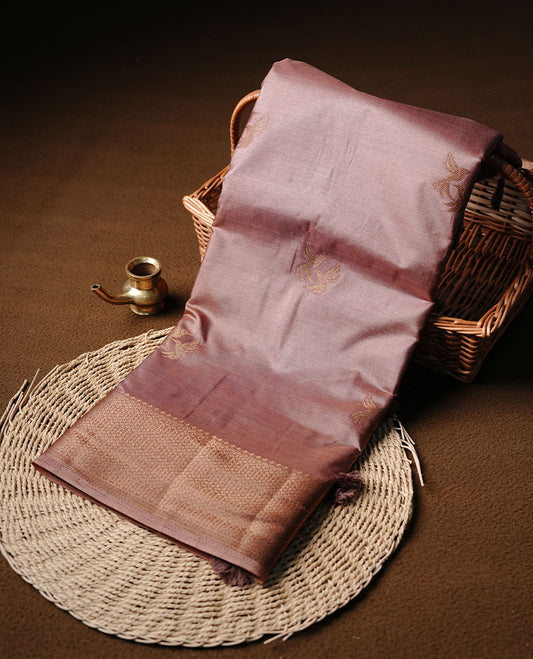 Coffee colour semi banaras tussar silk saree highlighting gold zari bird motifs on body, complemented by self colour with antique zari border, paired with matching blouse piece.