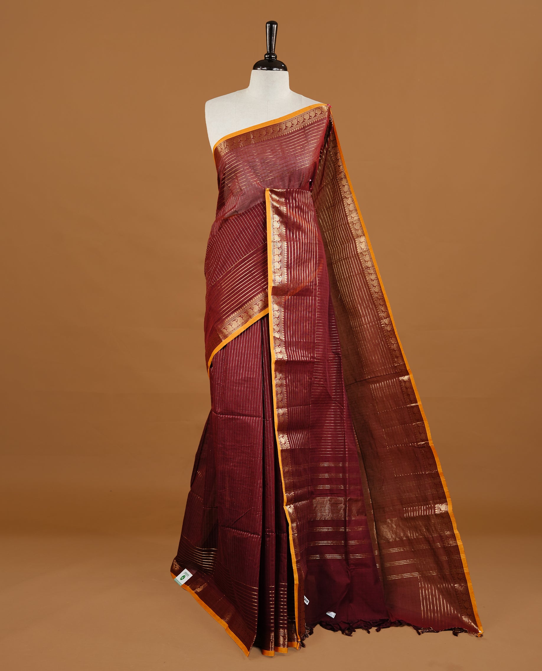Maroon colour Chettinad cotton saree featuring gold zari stripes on body , complemented by contrast Magenta colour with zari border, comes with matching blouse piece.
