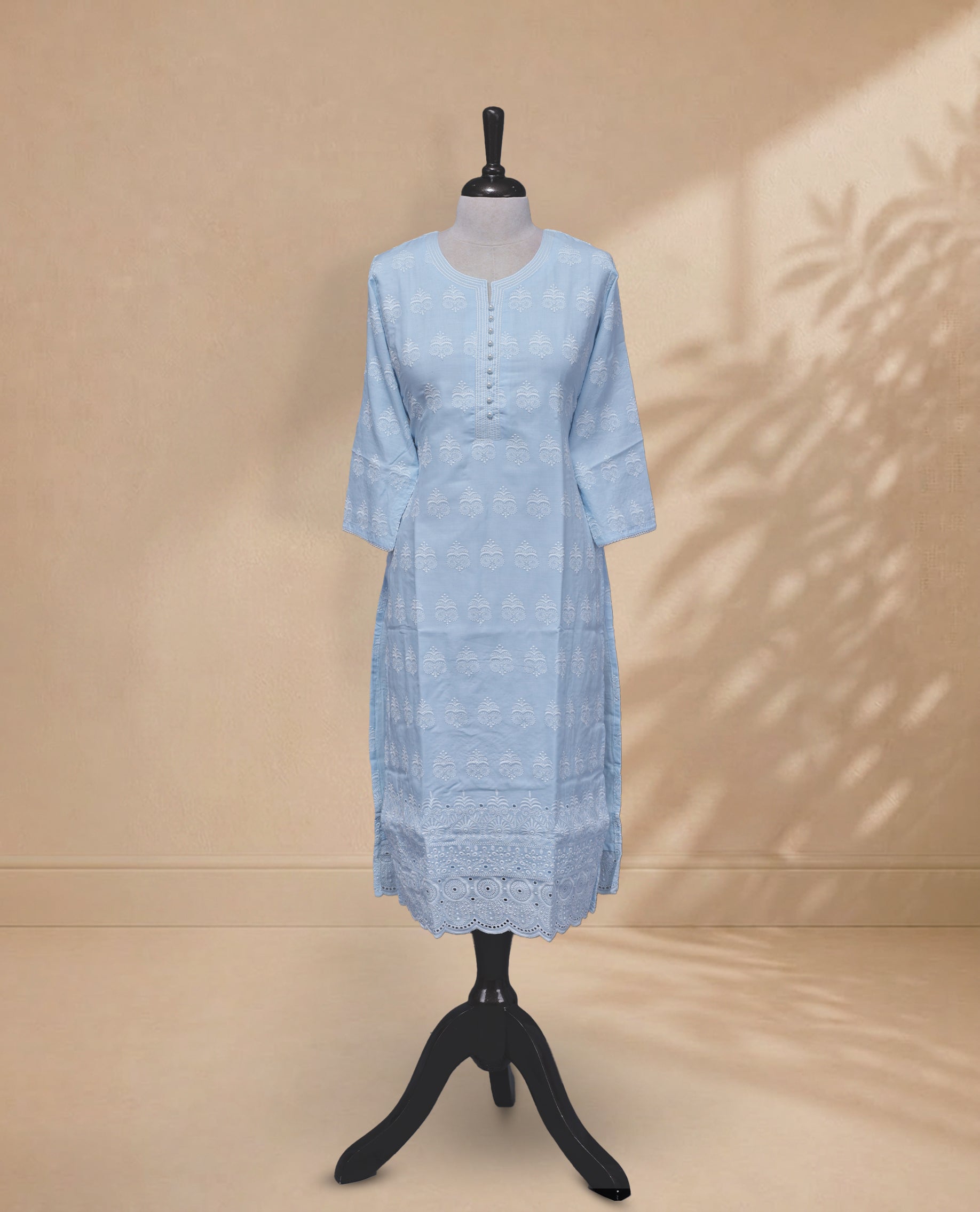 Sky Blue Colour kurti featuring a classic U-shaped Thread Pattern neckline, Beads  &  White Floral Prints on the body, and sleeves.