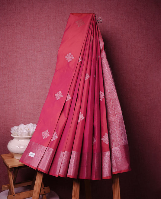 Red colour soft silk saree featuring rose Gold zari motifs on body, complemented by self colour with traditional border, paired with matching blouse piece.
