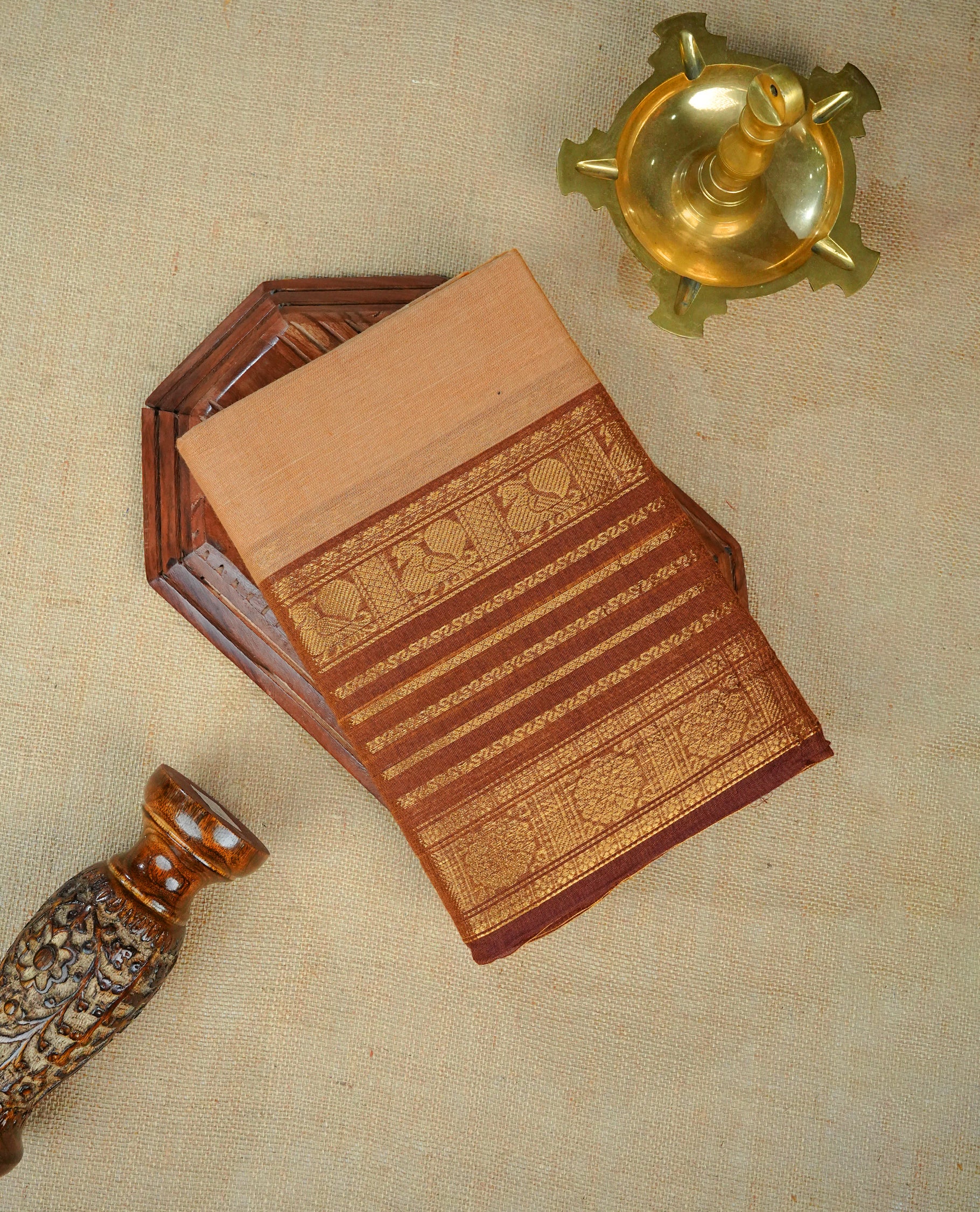 Cream colour chettinad cotton saree featuring Elegant plain body, complemented by contrast brown colour with gold zari strip & peacock border, comes with matching blouse piece.