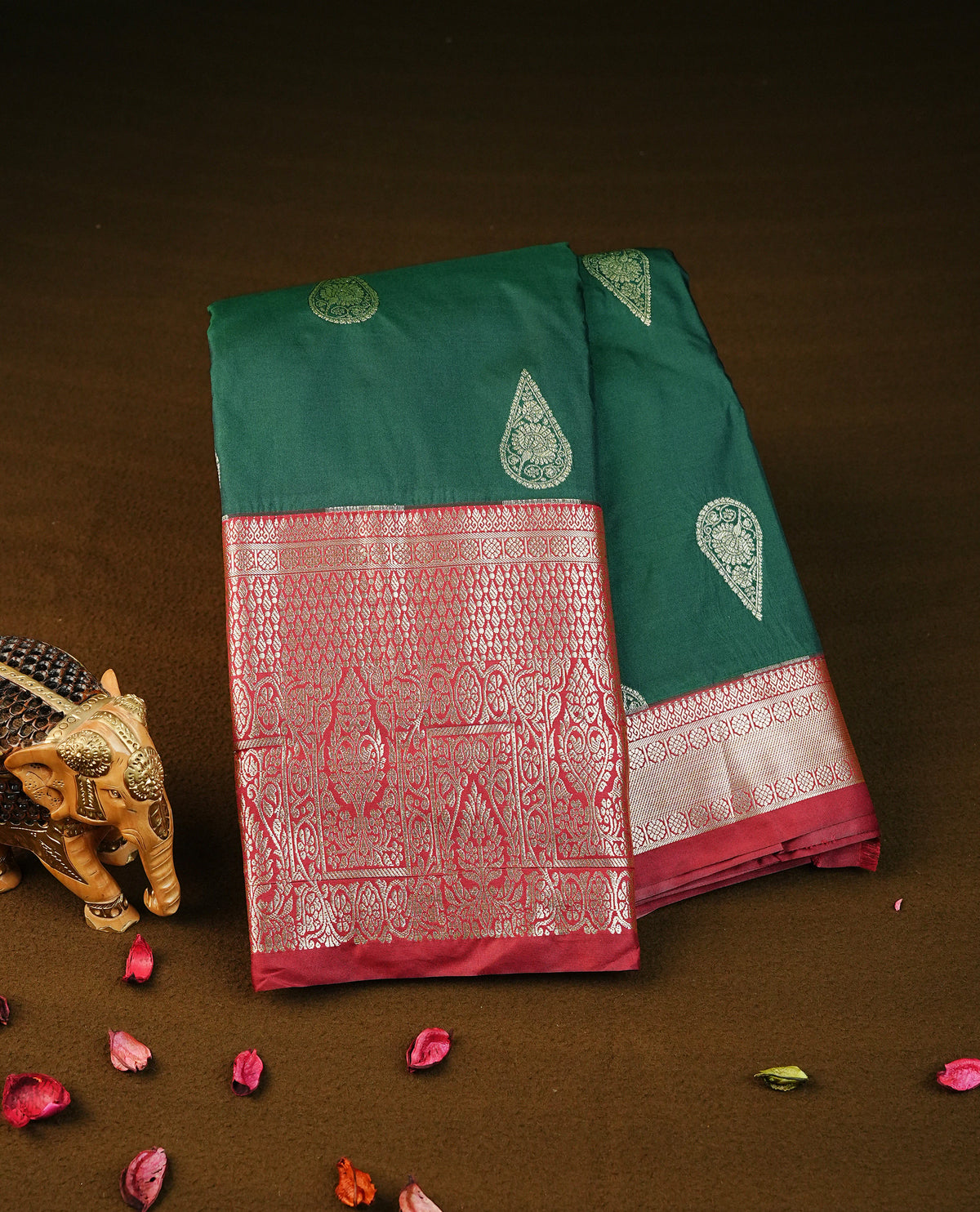 Bottle green colour semi wedding silk saree featuring light gold zari mango motifs on body, contrast maroon traditional border on body, rich pallu comes with matching blouse piece