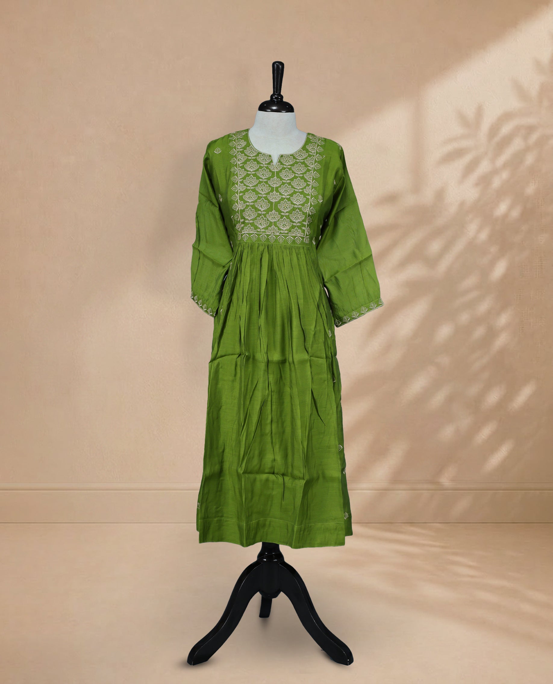 Green  kurti featuring a classic U-shaped neckline, Cream Colour  Floral Embroidery Work on the body, and sleeves.