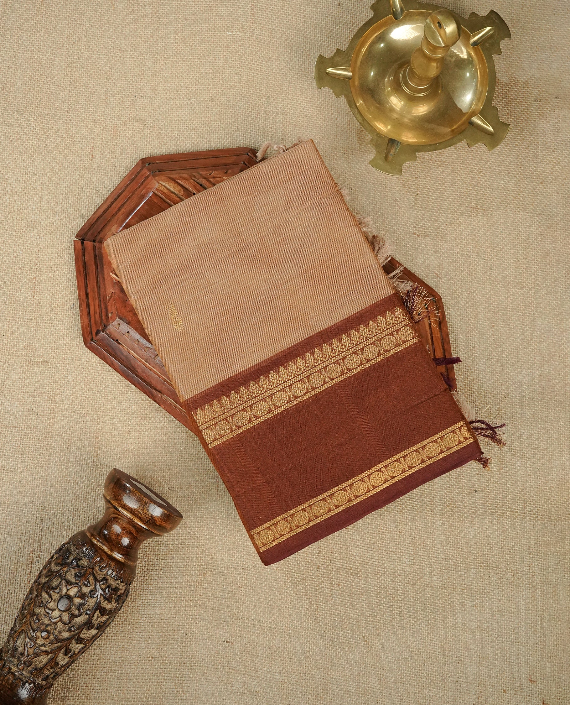 Beige colour chettinad cotton saree featuring gold zari motifs on body, Contrast Brown colour with Gold zari border, comes with matching blouse piece.