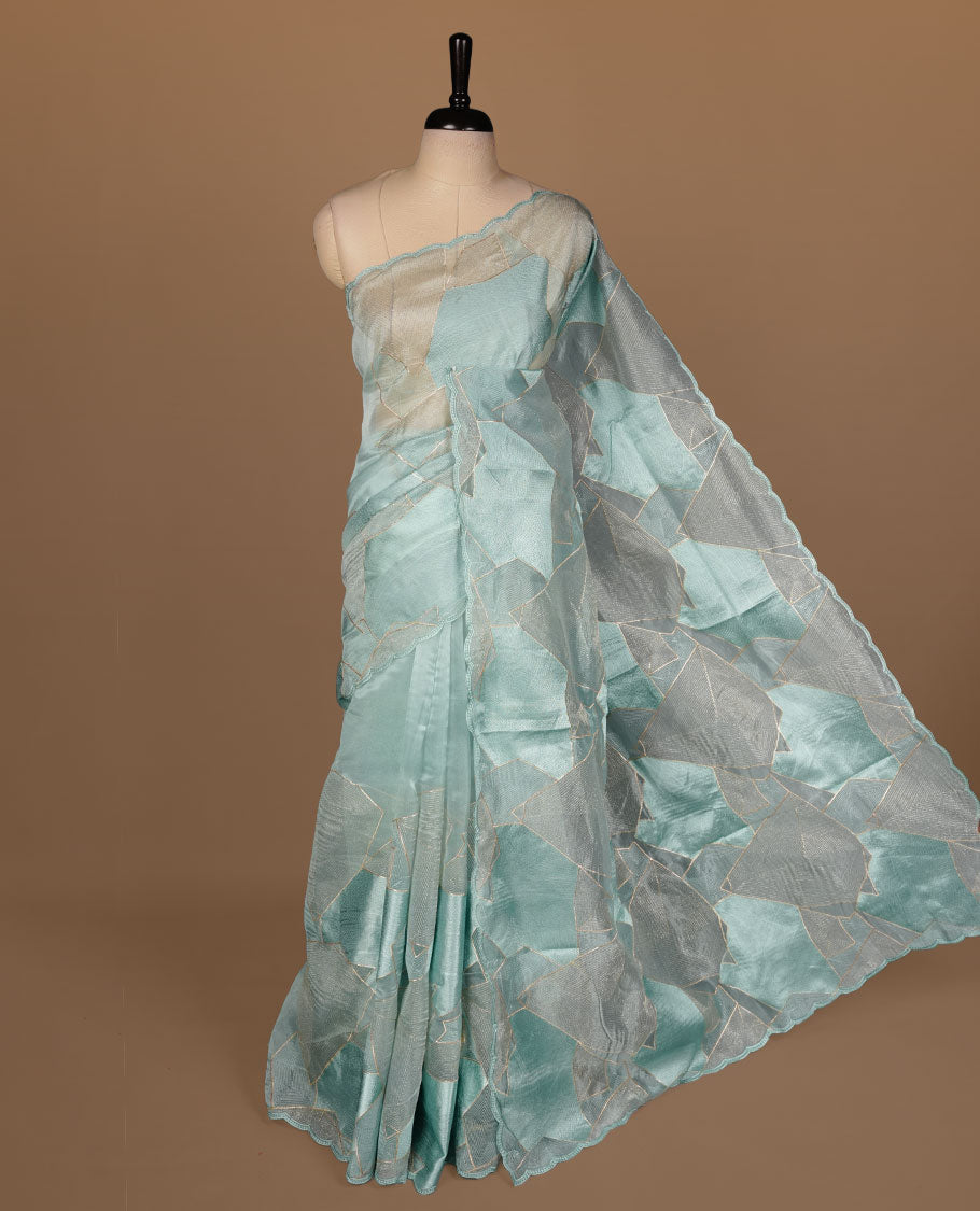 Mint blue colour Organza designer saree featuring a thread geometric pattern across the body, enhanced with a piping border and cut beats work on matching blouse piece.