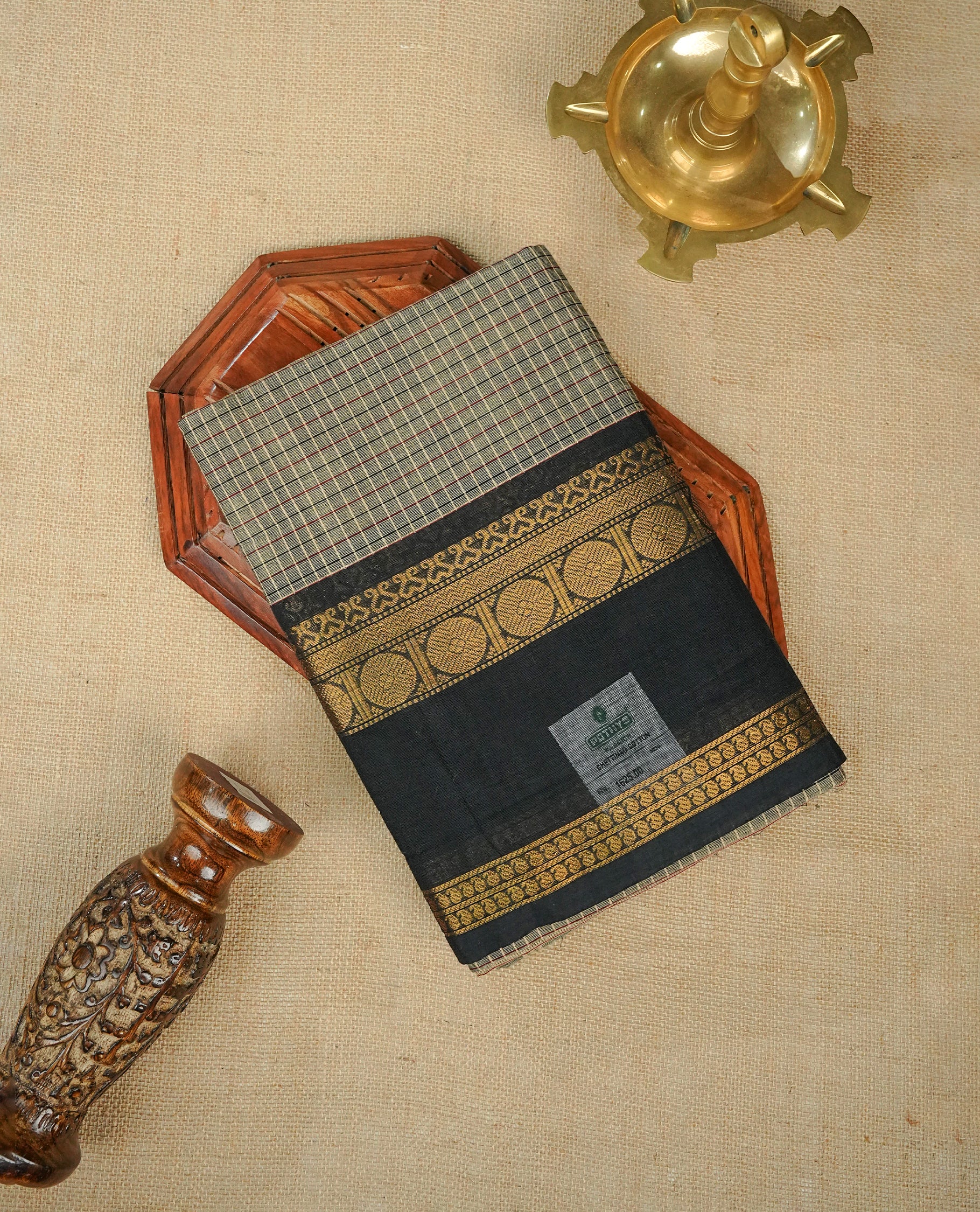 Grey colour chettinad cotton saree Featuring Gold zari check pattern on body, complemented by contrast black colour with zari border, comes with matching blouse piece.