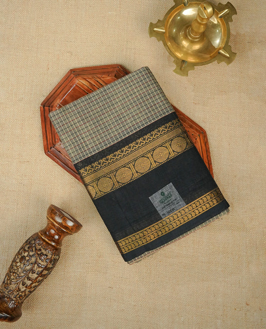 Grey colour chettinad cotton saree Featuring Gold zari check pattern on body, complemented by contrast black colour with zari border, comes with matching blouse piece.